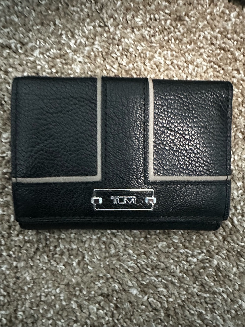Tumi Black Leather Wallet with Light Trim and Metal Logo